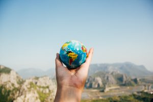 Person holding a globe in their hand